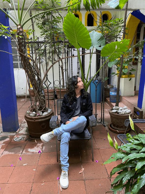 Joey on a patio in Mexico City surrounded by plants.